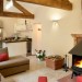 Limestone over underfoor heating. Corner sofa and armchair flank a Norwegian Jotul 6 log burner. 